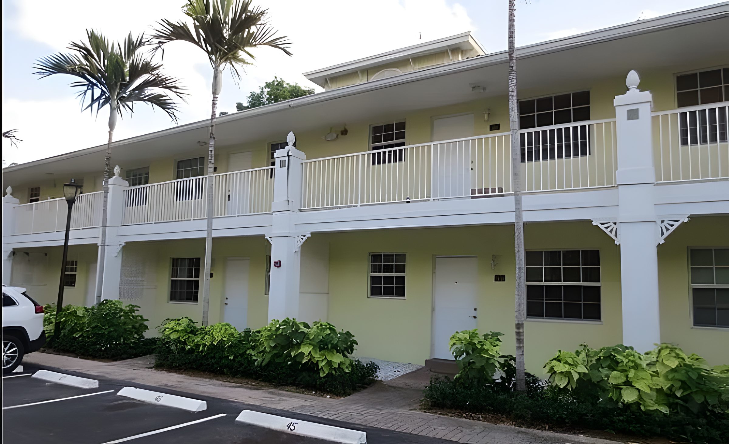 The cream and white buildings at The Grove, white columns, rails and outside stairs.